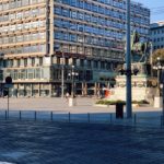 people walking on sidewalk near building during daytime