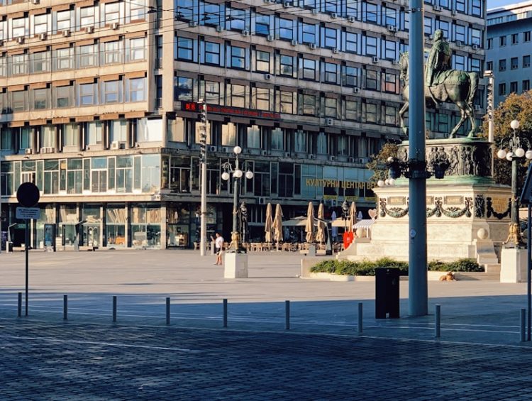 people walking on sidewalk near building during daytime