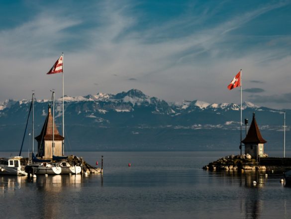 brown and white boat on water near brown wooden dock during daytime